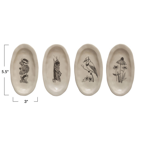 A set of four oval-shaped cream stoneware plates with nature-themed illustrations, such as a bee, a bird, a snail, and a plant.